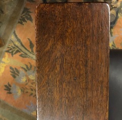 Image top of arm showing finish and quartered oak grain.